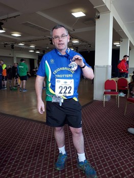 andy distin shows of his weymouth half marathon medal..jpeg