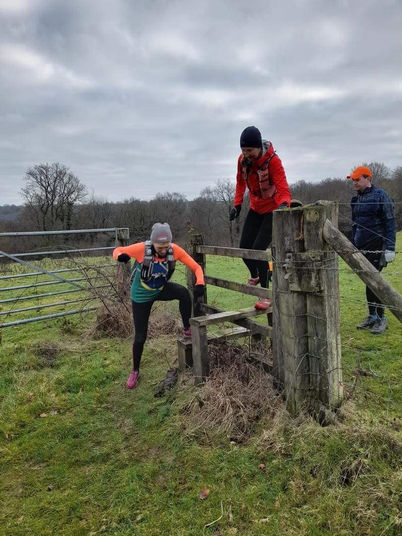 sue and karen climbs a stile.jpeg