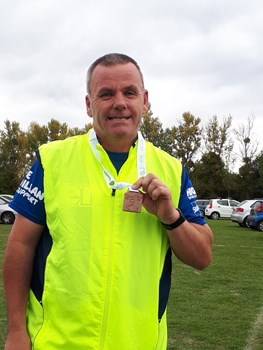 andy distin proudly shows off his medal at taunton 10k.jpg