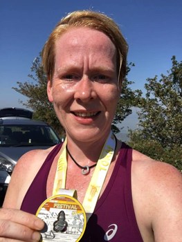 suzie with her medal at 401 festival of running.jpg