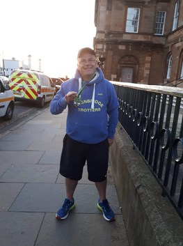 andy distin proudly displays his ayr half marathon medal.jpg