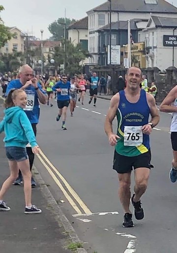 alex lyons with fan, lucy cheering him on.jpg