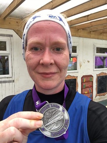 suzie mills shows off her hard earned medal at lopwell loop.jpg