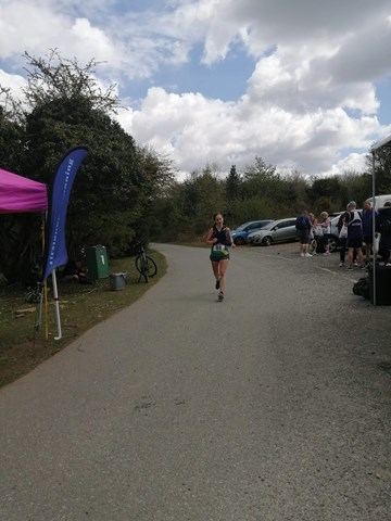 susanna goffe approaching the finish line having completed spring plymtrail marathon.jpeg
