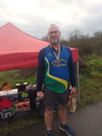 darren petch with his medal and goodie bag.jpeg