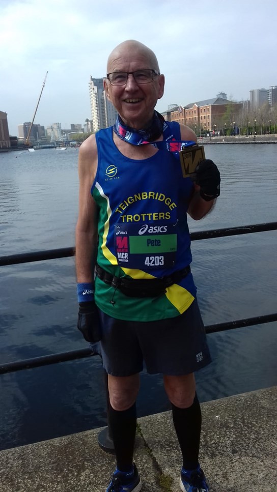 peter kirby holds his manchester marathon aloft.jpg