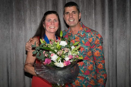 tinacaunter collects her life membership bouquet from roger hayes.jpg